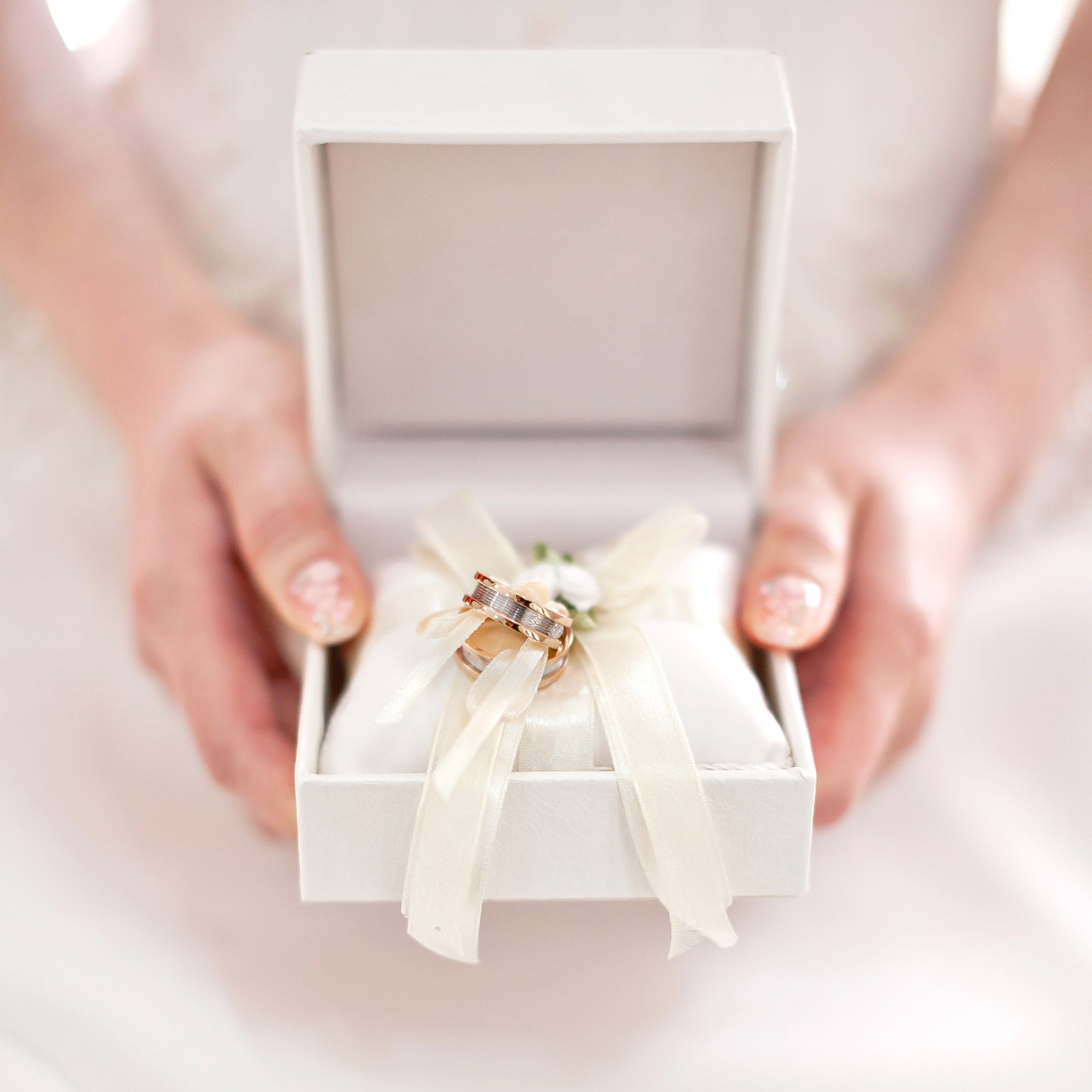 close-up-female-hand-holding-wedding-rings-box.jpg